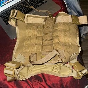 A tan dog harness, it is brand stinking new I got it for my dog but too big